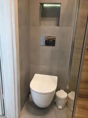 a bathroom with a toilet and a glass shower at Apartament Kraków Arena No. 100 in Kraków