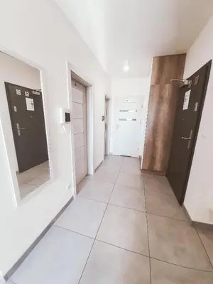a hallway with two doors and a tiled floor at Apartament Kraków Arena No. 100 in Kraków