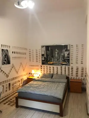a bedroom with a bed and a picture on the wall at Pokój Sali 2 in Kraków