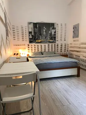 a bedroom with a bed and a table and a desk at Pokój Sali 2 in Kraków