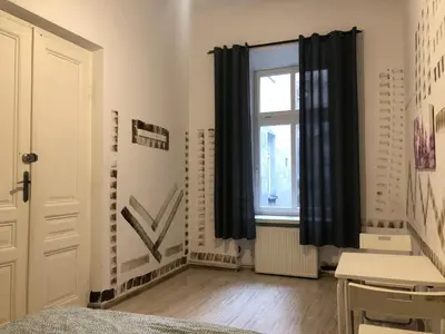 a bedroom with black curtains and a window at Pokój Sali 2 in Kraków