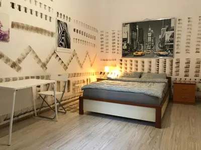 a bedroom with a bed and a desk in it at Pokój Sali 2 in Kraków