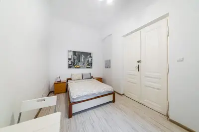 a small bedroom with a bed and a door at Pokój Sali 2 in Kraków