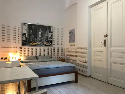 a bedroom with a bed and a white door at Pokój Sali 2 in Kraków