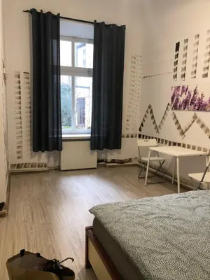 a bedroom with a window and a desk and a bed at Pokój Sali 2 in Kraków