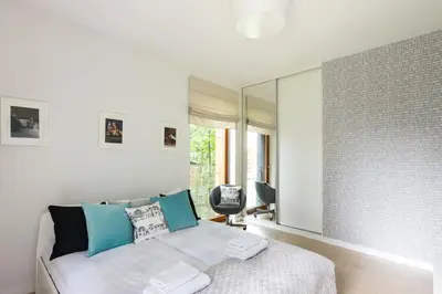 a bedroom with a bed and a mirror at Old Town Rakowicka by NEARTO in Kraków