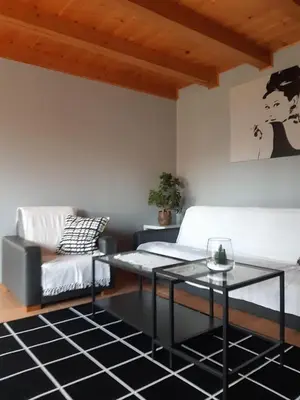 a living room with a couch and a table at Domek w górach in Sucha Beskidzka