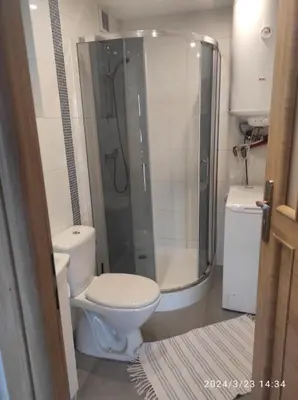 a bathroom with a toilet and a glass shower at Domek w górach in Sucha Beskidzka