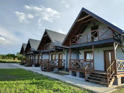 a row of houses with balconies in a row at Happy Holiday domki Zator in Zator