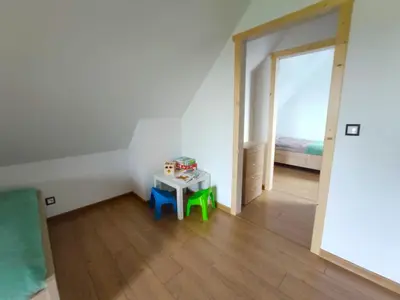 a room with a small table and a bed at Happy Holiday domki Zator in Zator