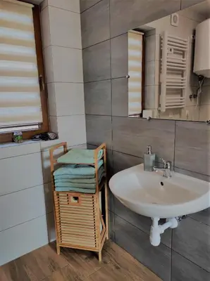 a bathroom with a sink and a mirror at Happy Holiday domki Zator in Zator
