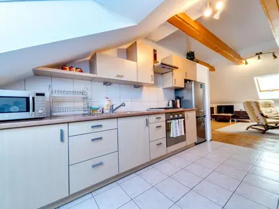 a kitchen with white cabinets and a microwave at Apartment Królowej Jadwigi by Interhome in Kraków