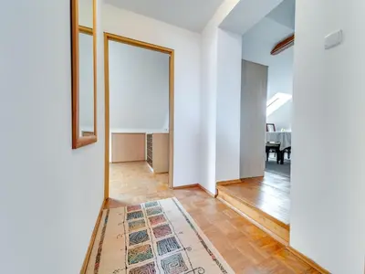 a hallway with a mirror and a rug at Apartment Królowej Jadwigi by Interhome in Kraków