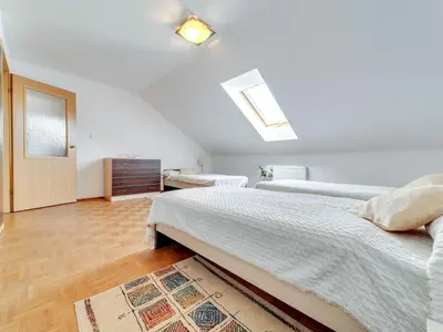 a bedroom with two beds and a skylight at Apartment Królowej Jadwigi by Interhome in Kraków