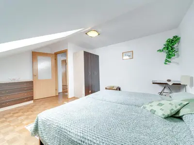 a bedroom with a large bed with a blue blanket at Apartment Królowej Jadwigi by Interhome in Kraków