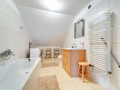a bathroom with a tub and a sink and a toilet at Apartment Królowej Jadwigi by Interhome in Kraków