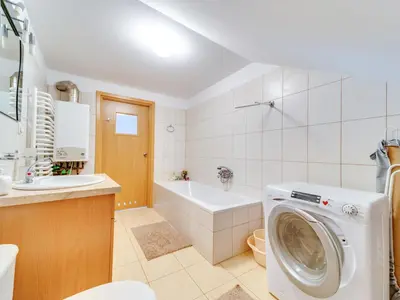 a bathroom with a washer and a washing machine at Apartment Królowej Jadwigi by Interhome in Kraków