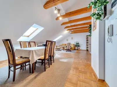 a dining room with a table and chairs at Apartment Królowej Jadwigi by Interhome in Kraków