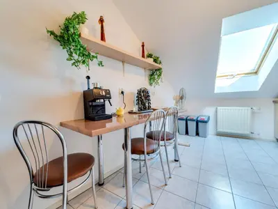 a kitchen with a table and chairs in a room at Apartment Królowej Jadwigi by Interhome in Kraków