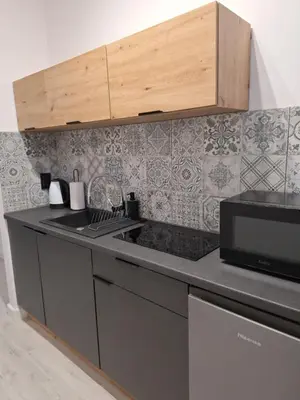 a kitchen with a sink and a microwave at Cracow by Night Apartments in Kraków