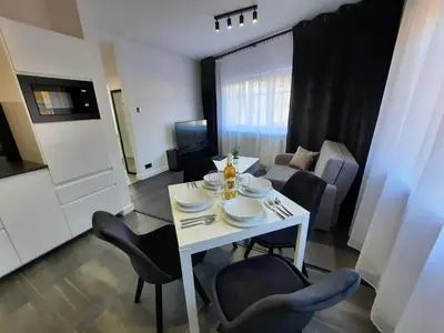 a white table and chairs in a living room at Cracow by Night Apartments in Kraków