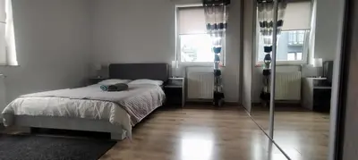 a kitchen with a sink and a black refrigerator at Pleasant private and fully equipped apartment with private parking space close to District Kazimierz in Kraków