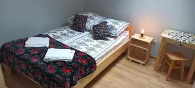 a bedroom with a bed and a table with a candle at Noclegi przy Skawie in Zator