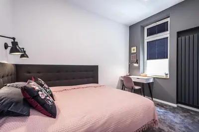 a bedroom with a bed and a desk and a window at NEW APARTMENT! Jewish quarter - SEGUNDO in Kraków