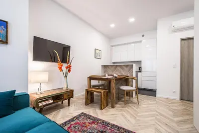 a living room with a blue couch and a table at NEW APARTMENT! Jewish quarter - SEGUNDO in Kraków