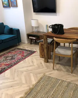 a living room with a wooden table and a blue couch at NEW APARTMENT! Jewish quarter - SEGUNDO in Kraków