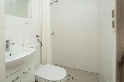 a bathroom with a toilet and a sink and a shower at Noclegi Pod Dębem u Jakuba in Niepołomice