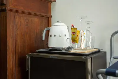 a slow cooker sitting on top of a refrigerator at Noclegi Pod Dębem u Jakuba in Niepołomice