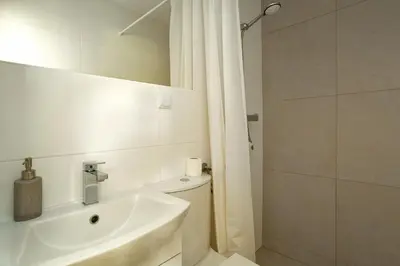 a bathroom with a toilet and a sink and a shower at Noclegi Pod Dębem u Jakuba in Niepołomice