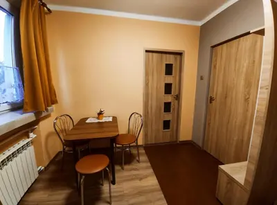a small dining room with a table and chairs at Villa For You in Oświęcim