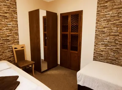 a room with two beds and a door with a mirror at Villa For You in Oświęcim