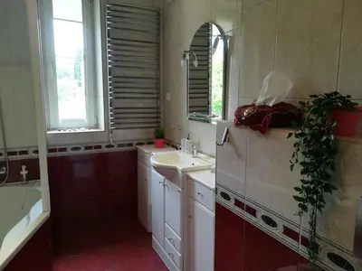 a bathroom with a sink and a tub and a mirror at Villa For You in Oświęcim