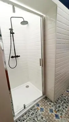 a shower with a glass door in a bathroom at Wieliczka City Apartments in Wieliczka