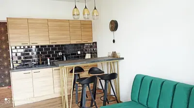 a kitchen with stools in front of a counter at Wieliczka City Apartments in Wieliczka