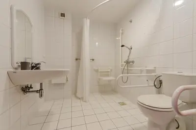 a white bathroom with a toilet and a sink at HOTEL A4 Airport Kraków MOP Morawica in Aleksandrowice