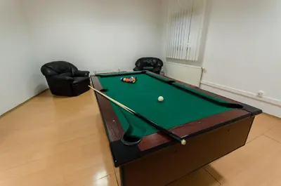 a pool table with a ball in a room at HOTEL A4 Airport Kraków MOP Morawica in Aleksandrowice