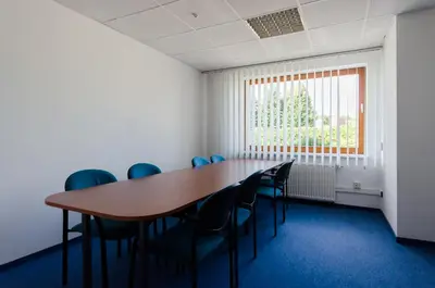 a conference room with a long table and chairs at HOTEL A4 Airport Kraków MOP Morawica in Aleksandrowice
