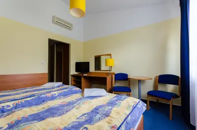 a hotel room with a bed and a desk and chairs at HOTEL A4 Airport Kraków MOP Morawica in Aleksandrowice