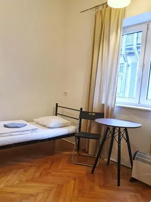 a room with a bed and a table and a window at VIKI Kazimierz in Kraków