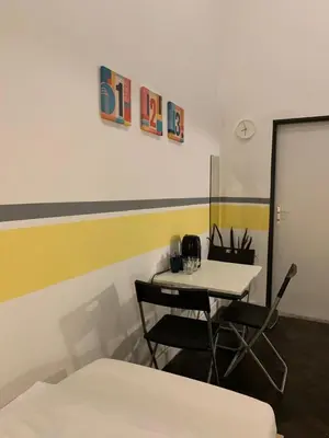 a room with a table and two chairs and a white table at VIKI Kazimierz in Kraków