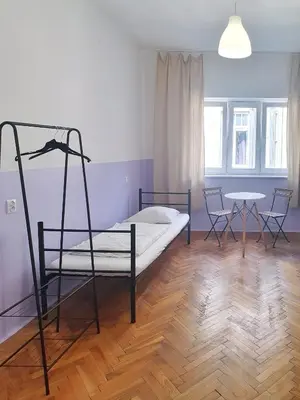 a bedroom with a bed and a table and chairs at VIKI Kazimierz in Kraków