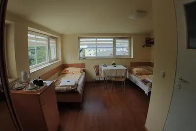 a room with two beds and a table in it at Nawojka Hotele Studenckie in Kraków