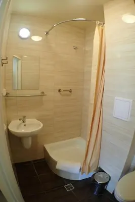 a bathroom with a sink and a shower and a toilet at Nawojka Hotele Studenckie in Kraków