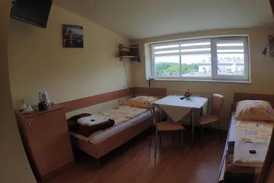 a room with a bed and a table and a window at Nawojka Hotele Studenckie in Kraków
