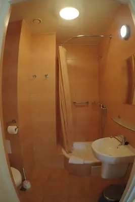 a bathroom with a sink and a shower and a toilet at Nawojka Hotele Studenckie in Kraków