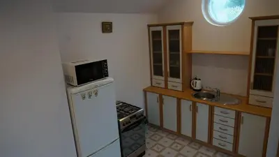 a kitchen with a white refrigerator and a microwave at DOM NA SKARPIE in Mszana Górna